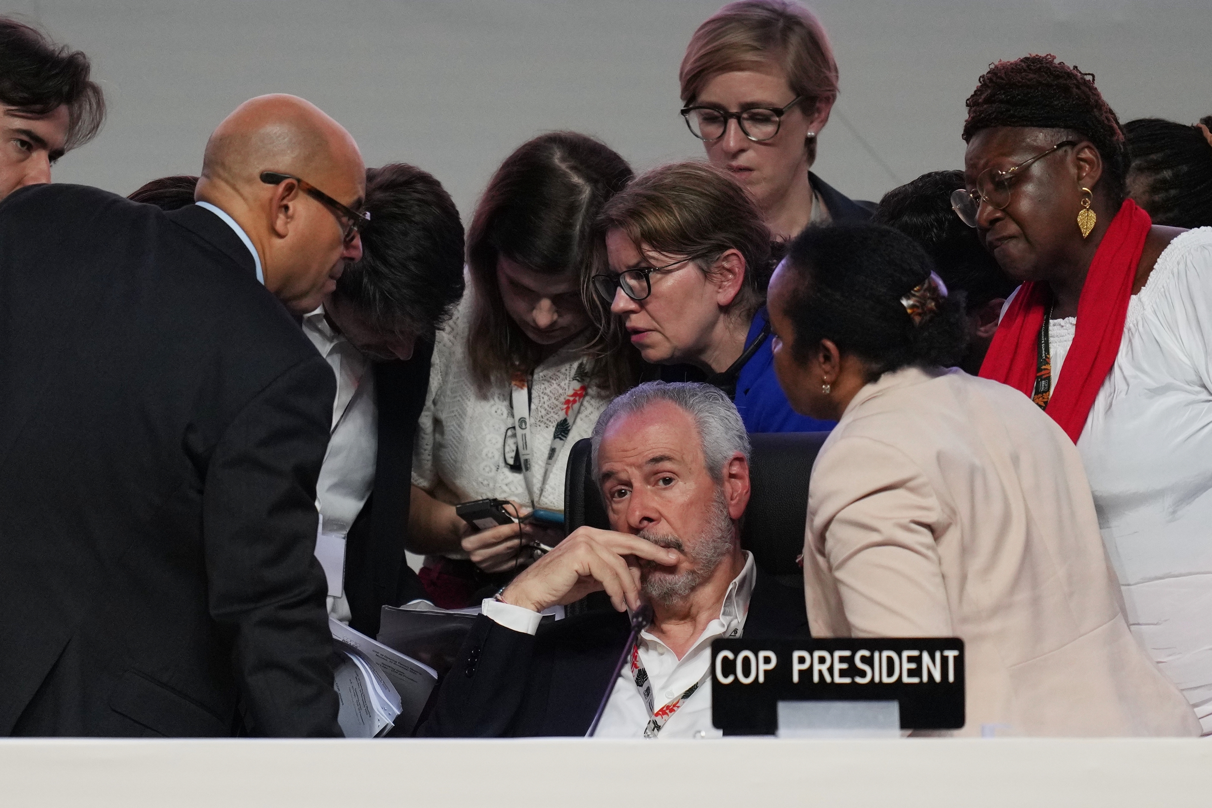 André Corrêa do Lago, center, the president of the COP30 climate conference in Brazil, sat as negotiators huddled in last-minute deliberations on Saturday.